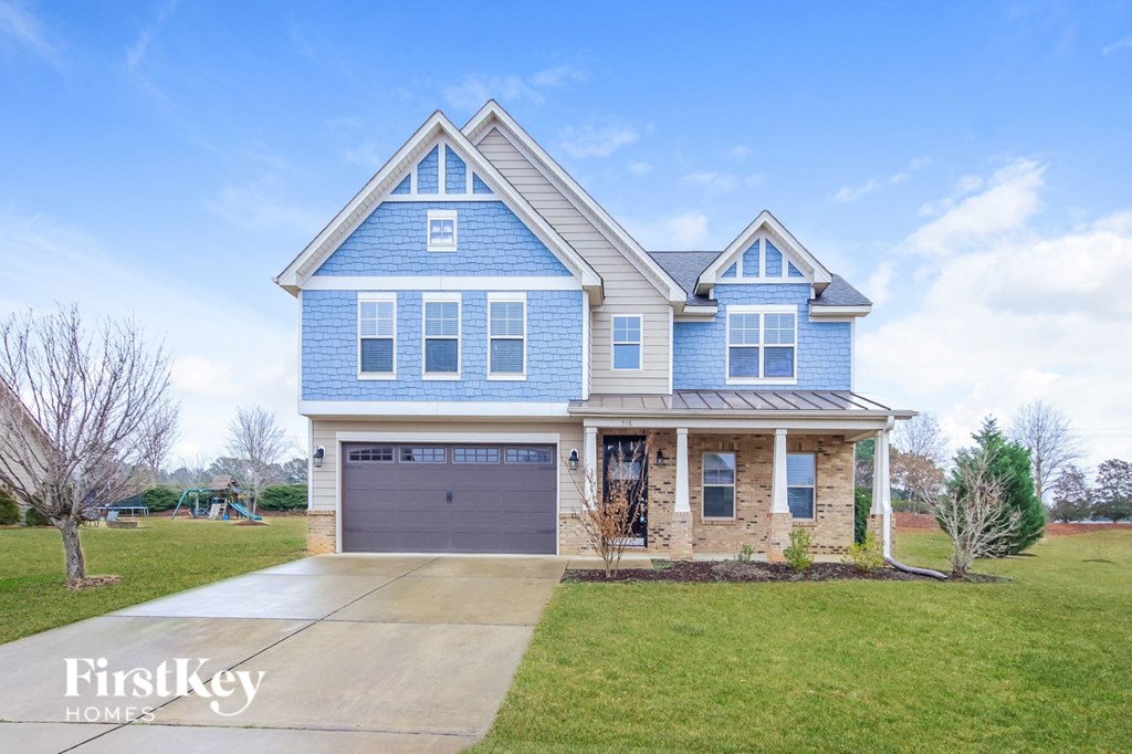 A blue house with a garage is for sale.