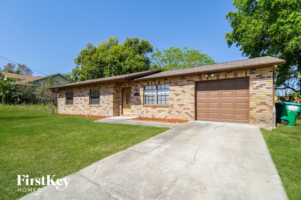 A house with a brown garage door is for sale.