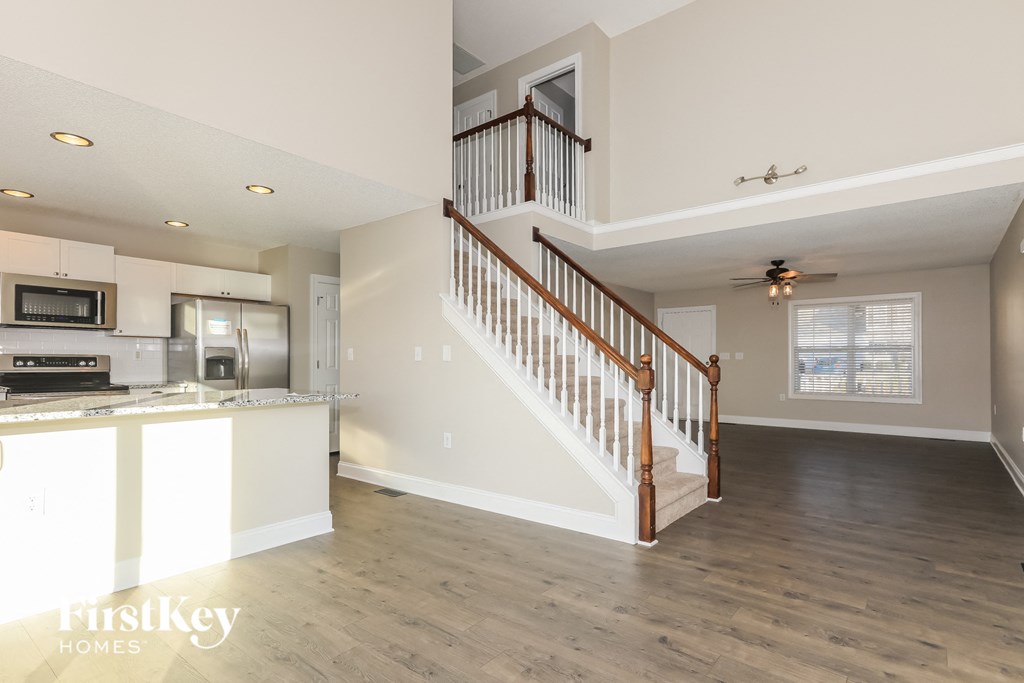 A spacious open floor plan with a staircase leading to the second level.