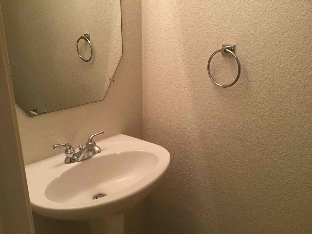 a small bathroom with a sink and a mirror