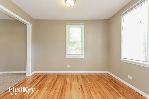 the second bedroom is spacious and has a hard wood floor