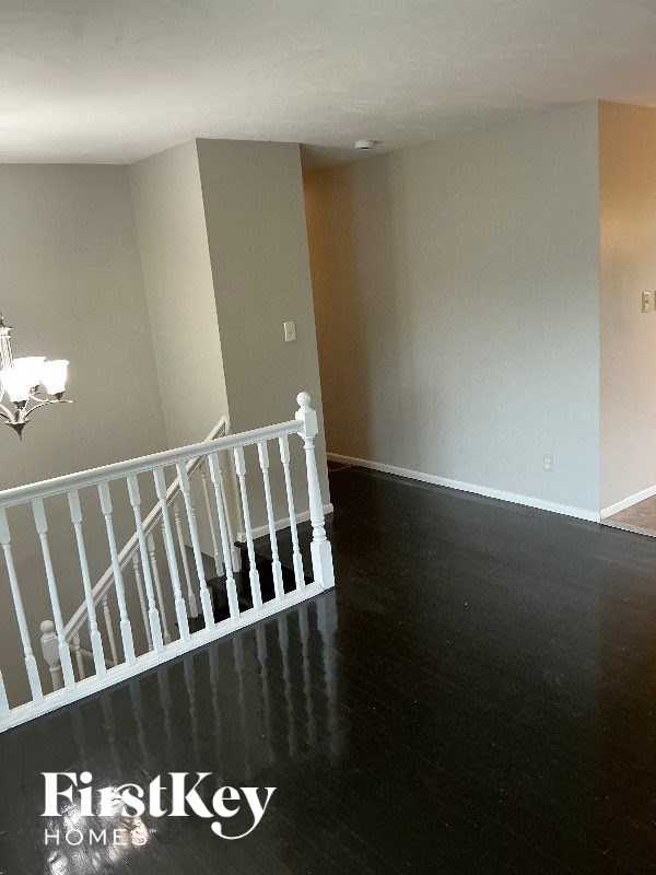 A room with a staircase and a chandelier.
