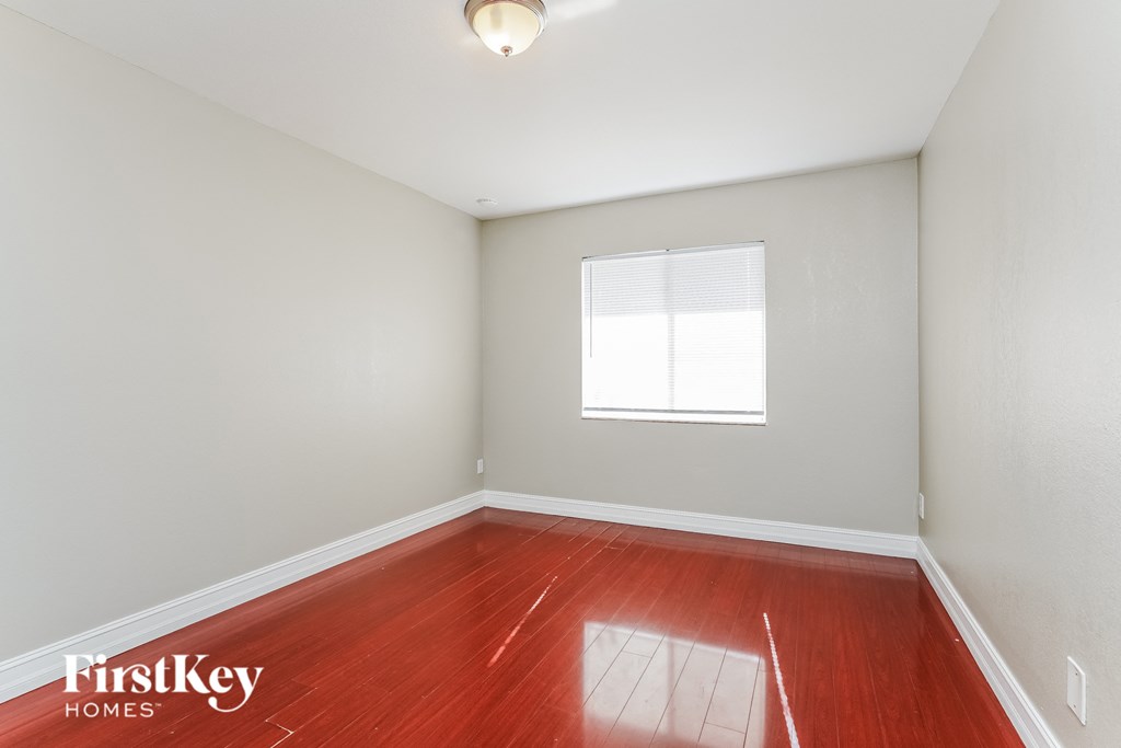 a empty room with wood floors and a window