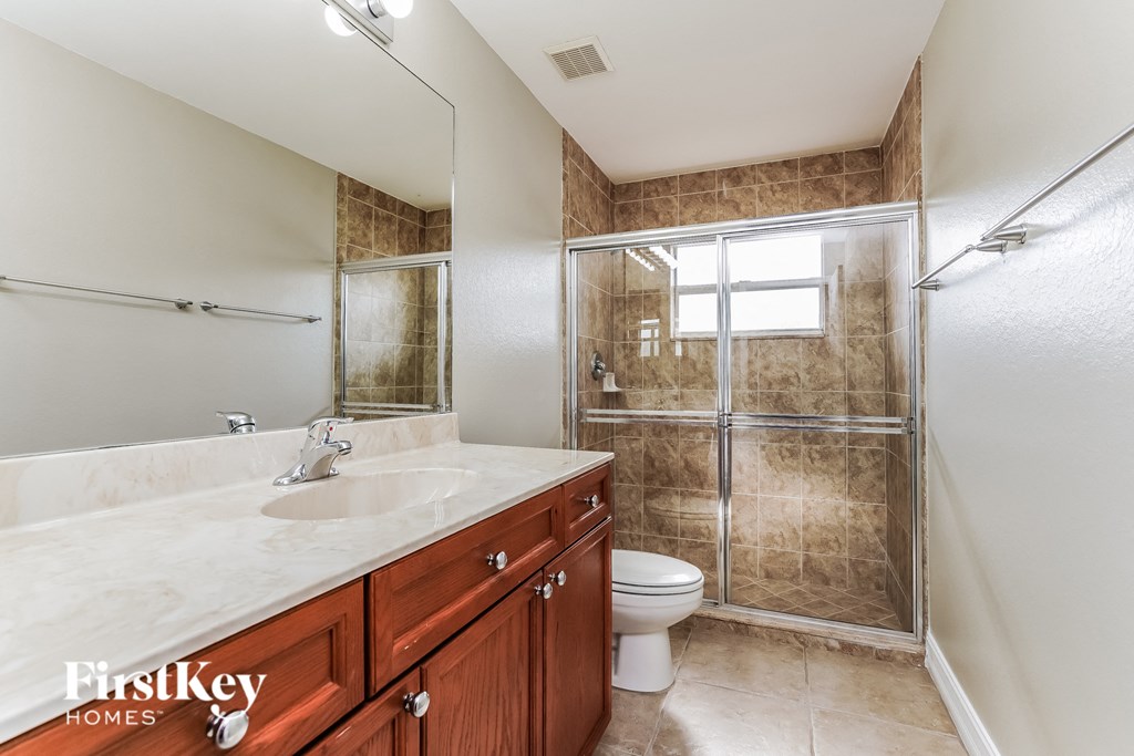 a bathroom with a shower toilet and sink