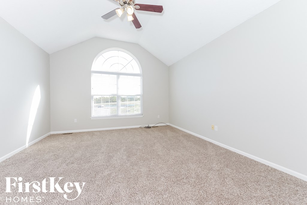 A room with a fan and a window.