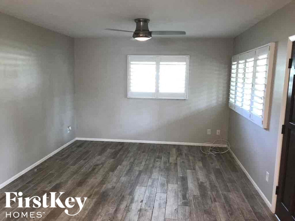 a empty room with wood floors and a window