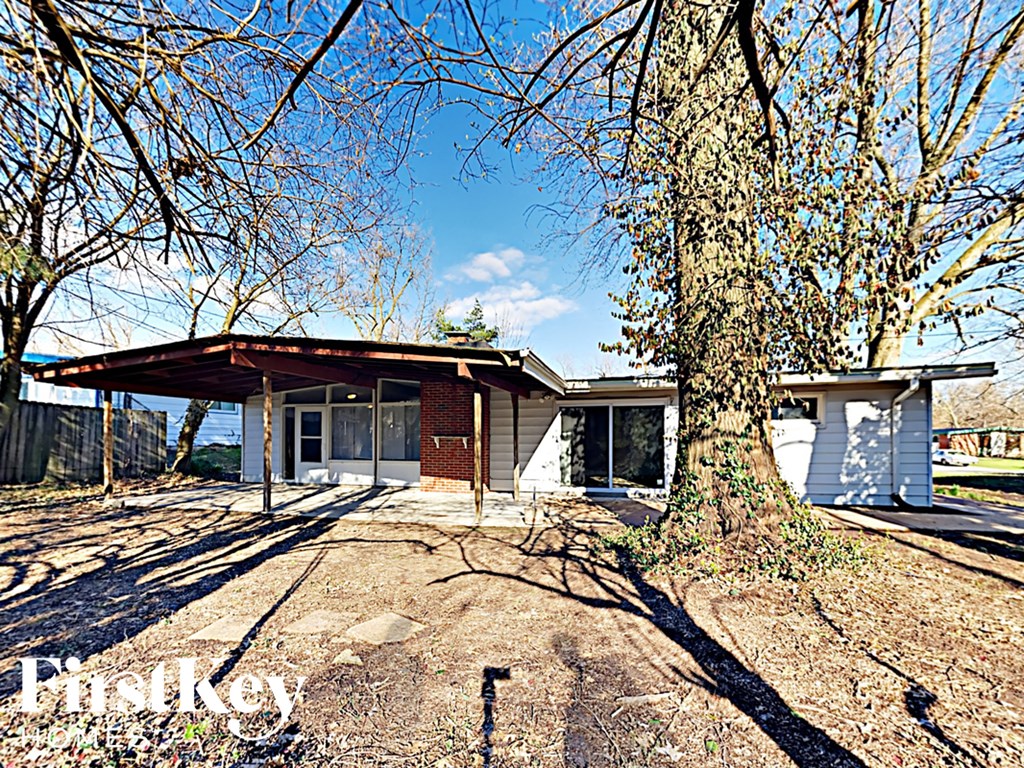 a small house with a tree in front of it