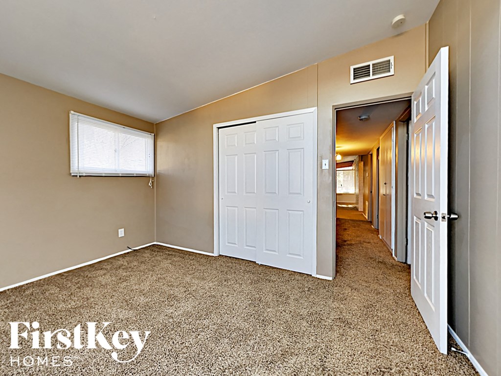 the upstairs hallway of a house with a white door