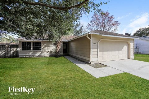 a home with a white garage door and a lawn