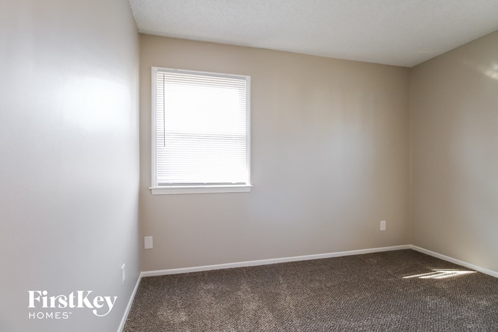 a room with a carpeted floor and a window