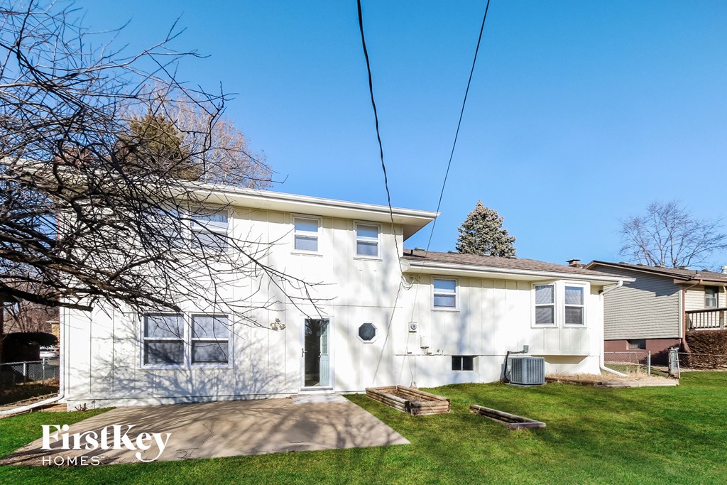 a white house with a yard and a blue sky