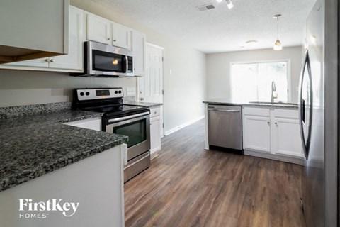 a kitchen with granite counter tops and stainless steel appliances