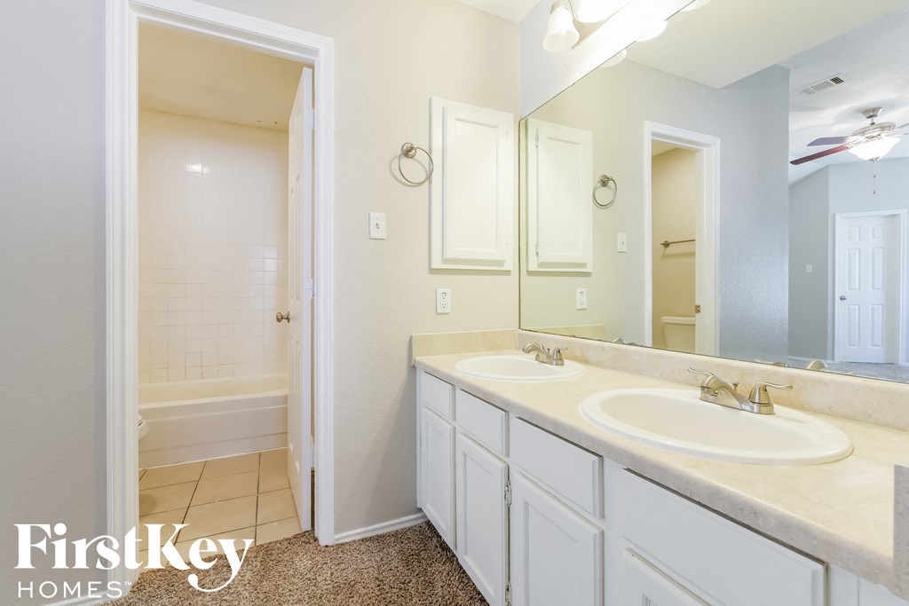 a bathroom with two sinks and a large mirror