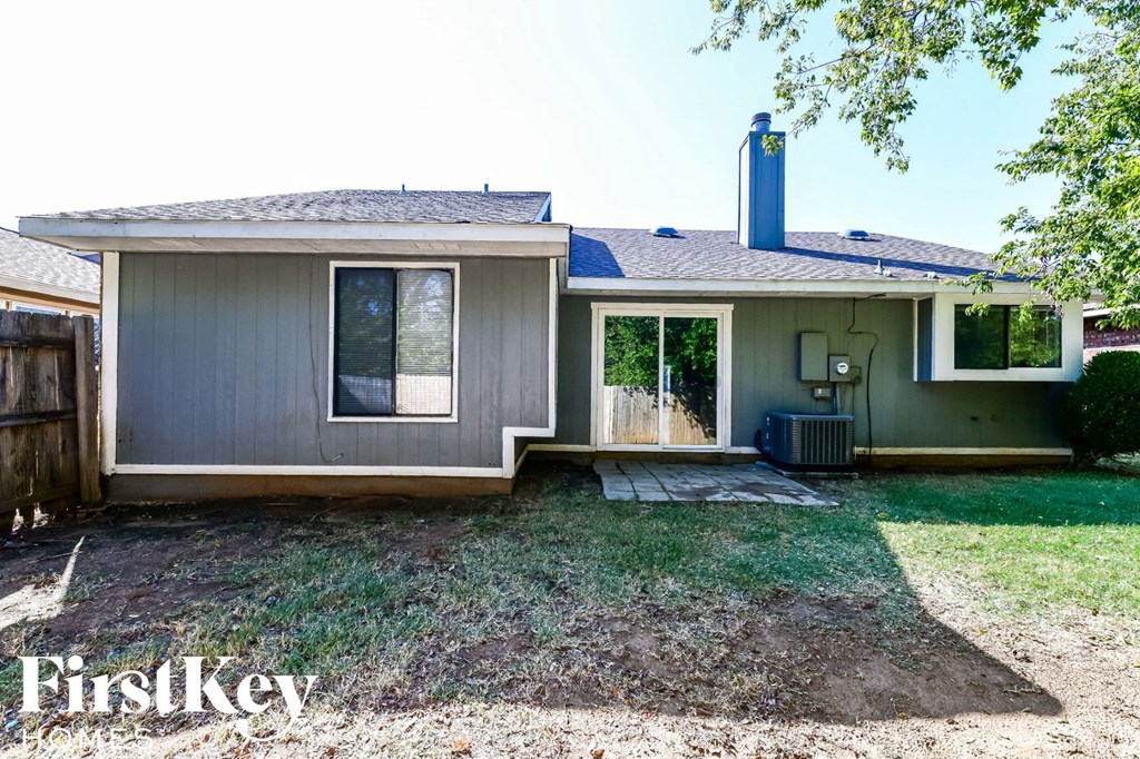 the front of a house with a yard and a backdoor