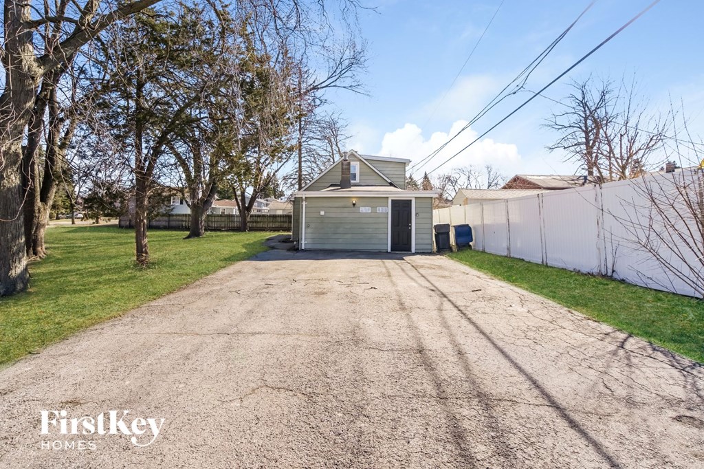 a garage with a garage door on the side of a driveway