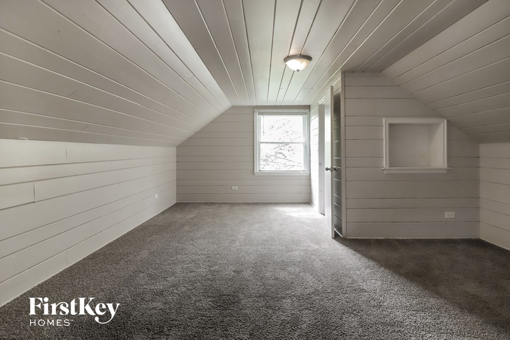 the tiny house room has a carpeted floor and a window