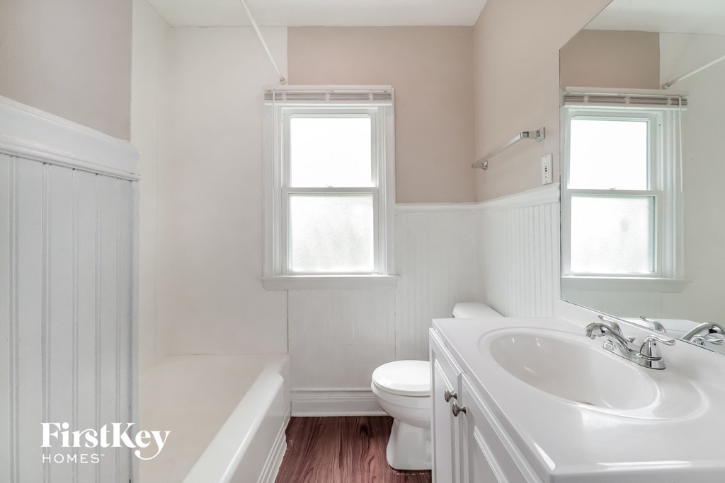 a bathroom with a sink and a toilet and a bath tub