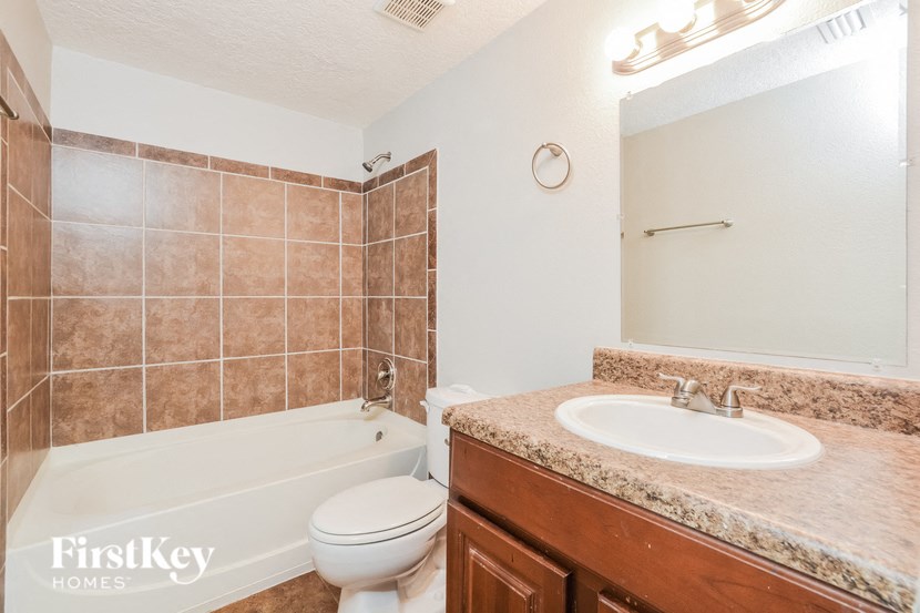 a bathroom with a sink toilet and a bath tub