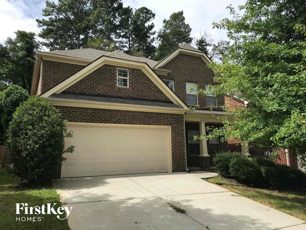 a house with a garage door in front of it