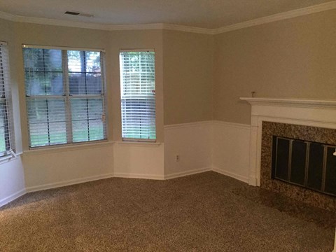 a living room with a fireplace and a window