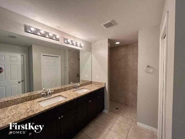 a bathroom with two sinks and a large mirror