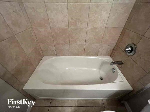 a bathroom with a toilet and a bath tub