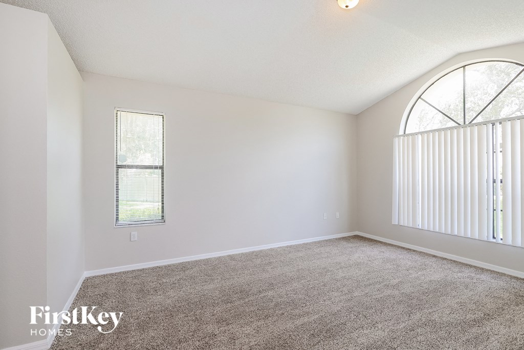 a living room with carpet and a large window