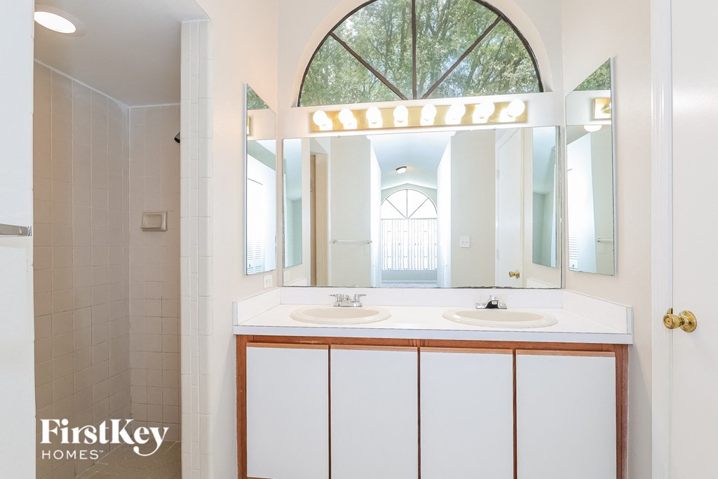 a bathroom with two sinks and a large mirror