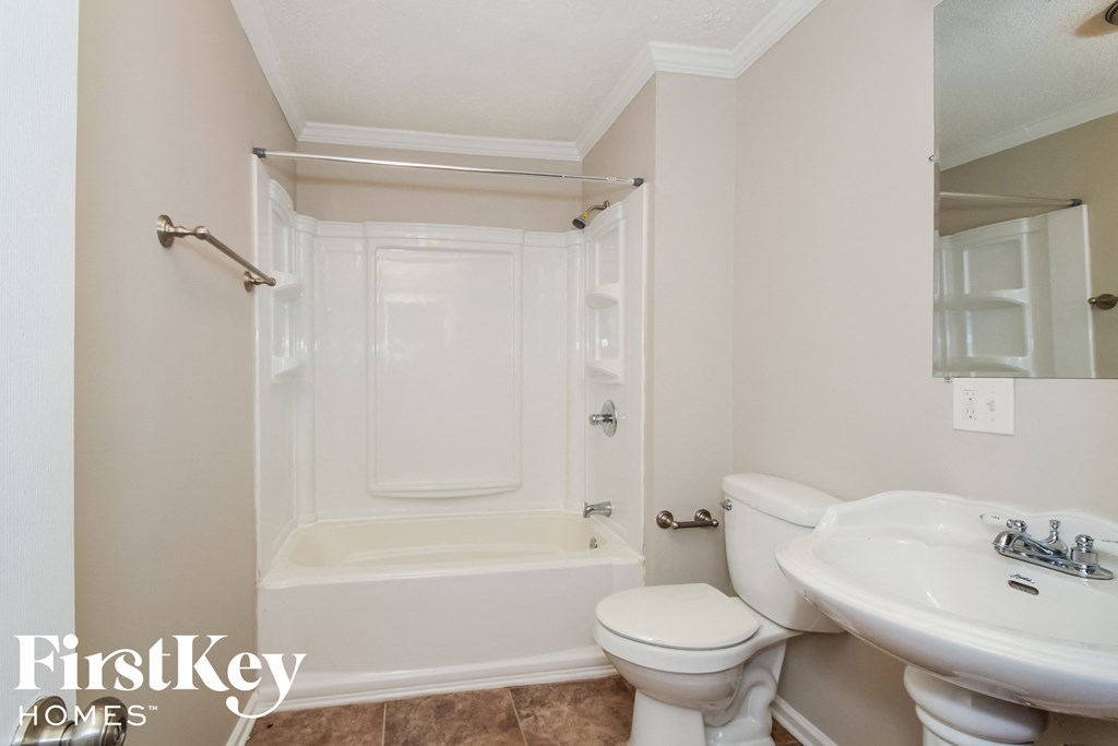 a bathroom with a sink toilet and a shower