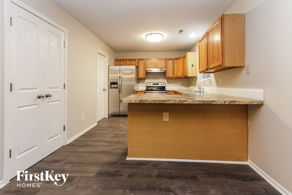 a kitchen with a counter top and a refrigerator