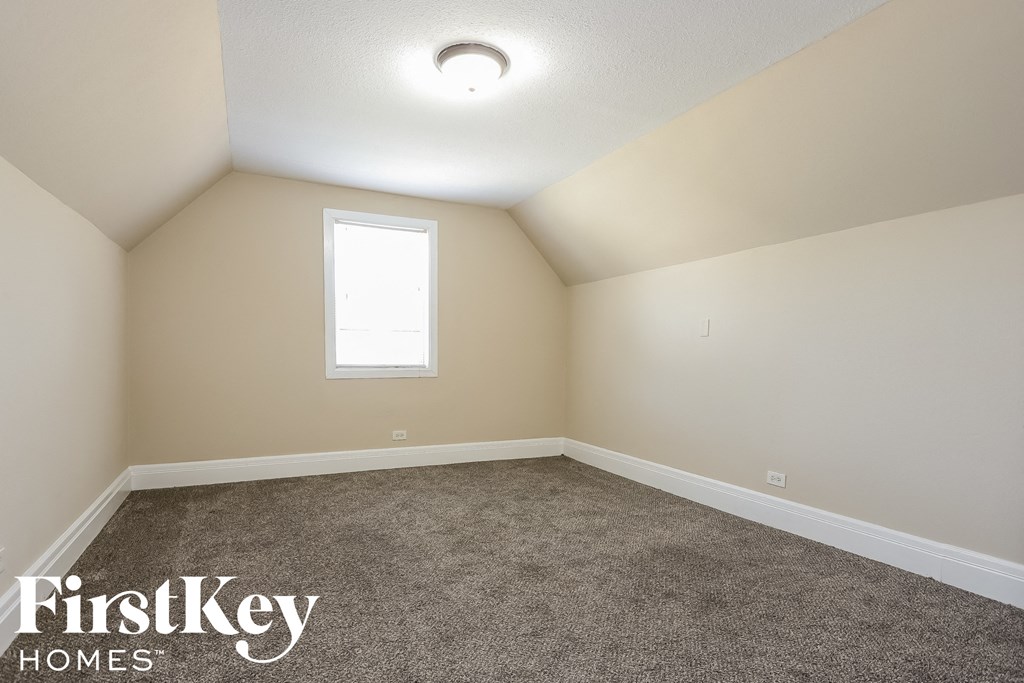 a empty room with carpet and a window