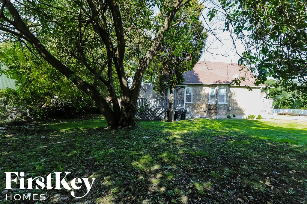 a large tree in front of a house