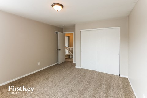 a bedroom with a closet and a door to a hallway