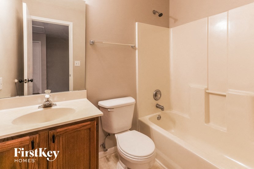 a bathroom with a sink toilet and a bath tub
