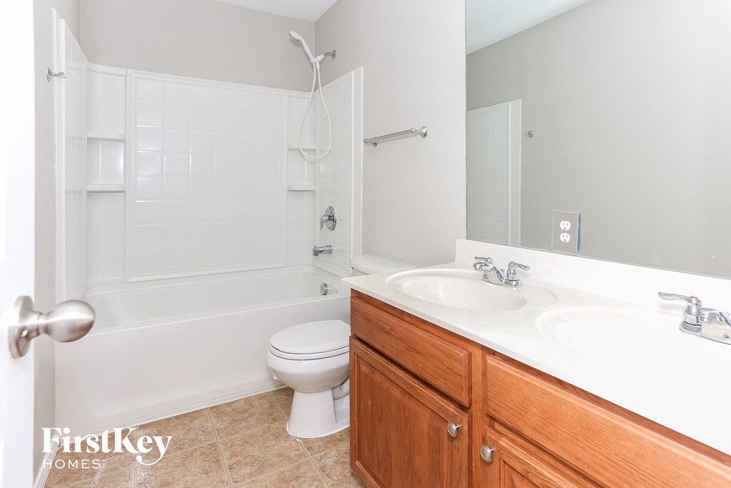 a bathroom with a toilet and a sink and a tub