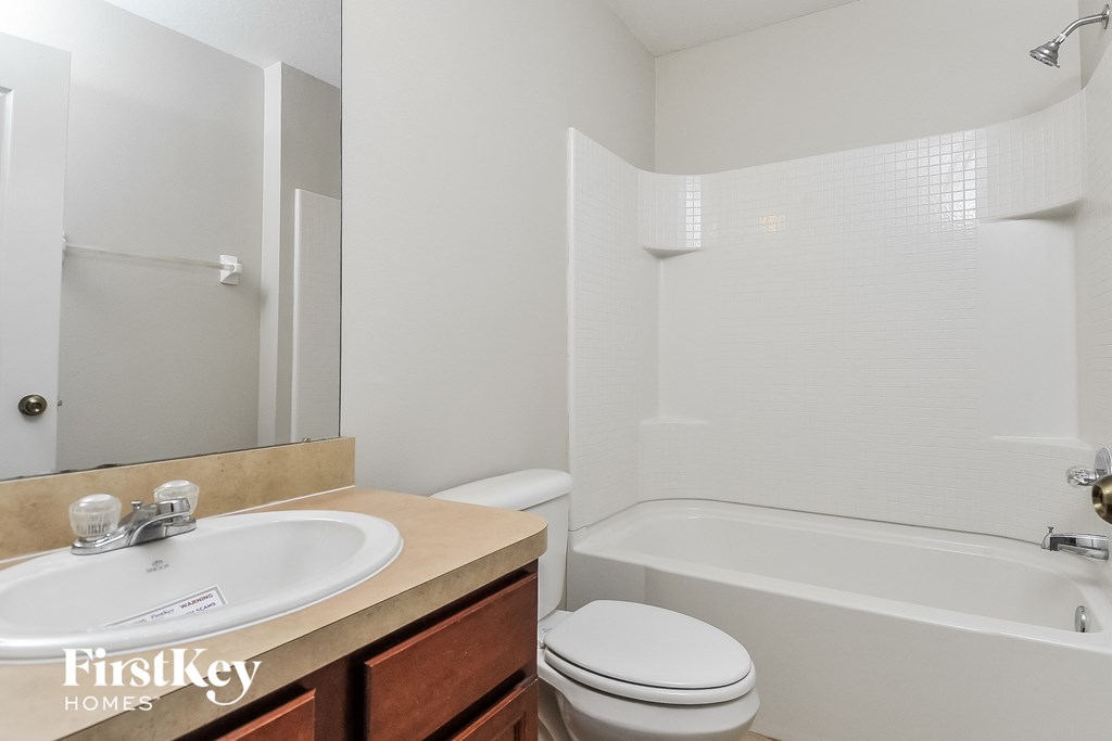 a bathroom with a sink toilet and bath tub