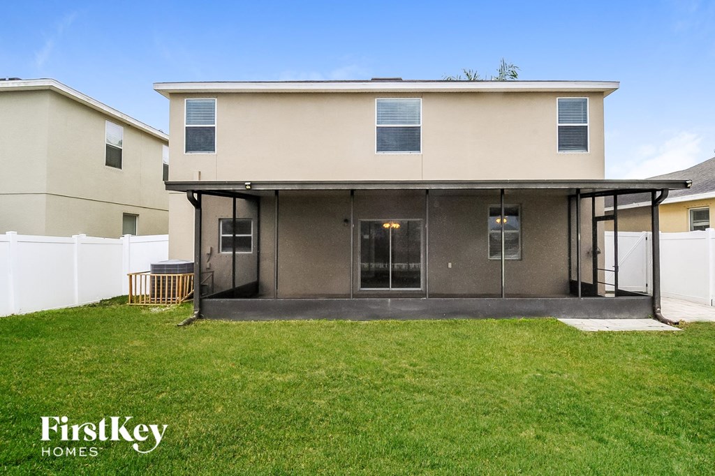 the front of a house with a lawn and a porch