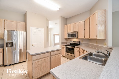 a kitchen with wooden cabinets and stainless steel appliances