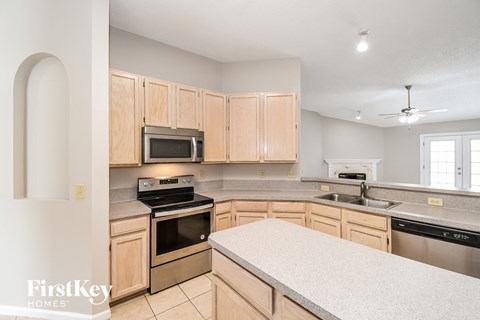 a kitchen with wooden cabinets and stainless steel appliances