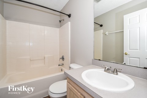 a bathroom with a sink and a toilet and a tub