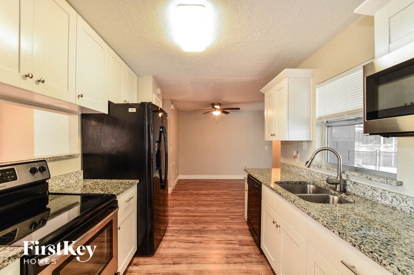 a kitchen with black appliances and granite counter tops