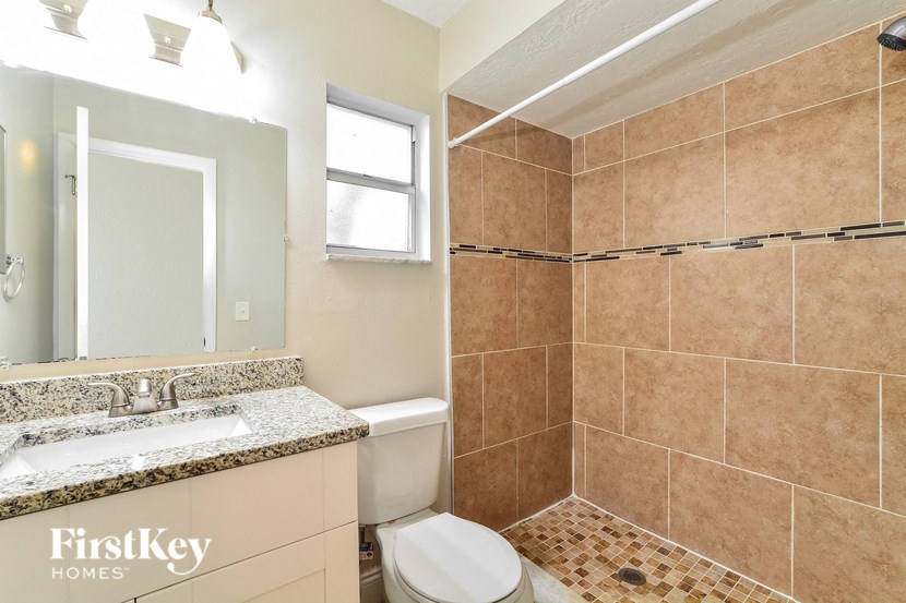 a bathroom with a toilet and a sink and a mirror