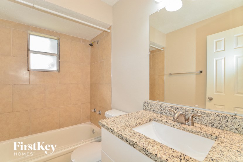 a bathroom with a sink and a toilet and a tub