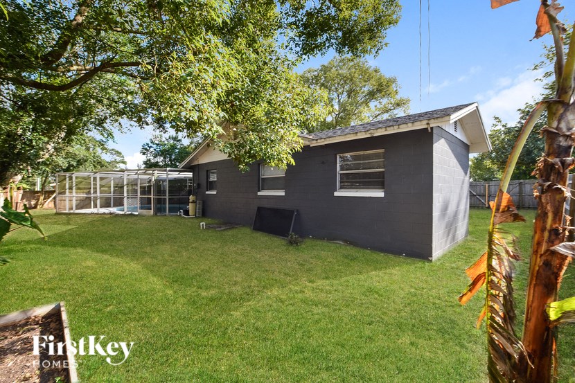 a backyard with a house and a greenhouse