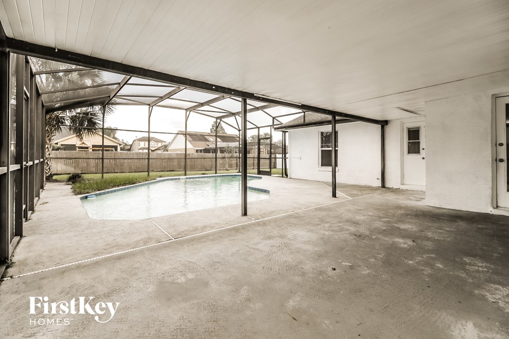 A pool inside a house with FirstKey Homes logo.