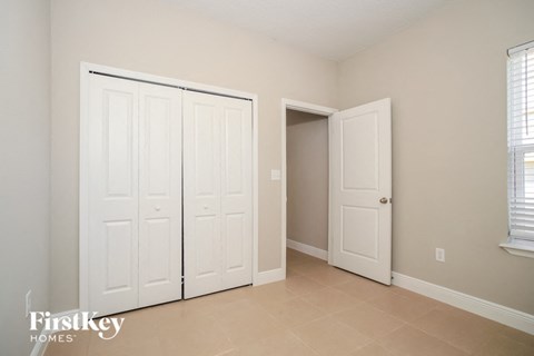 a bedroom with two closets and two doors