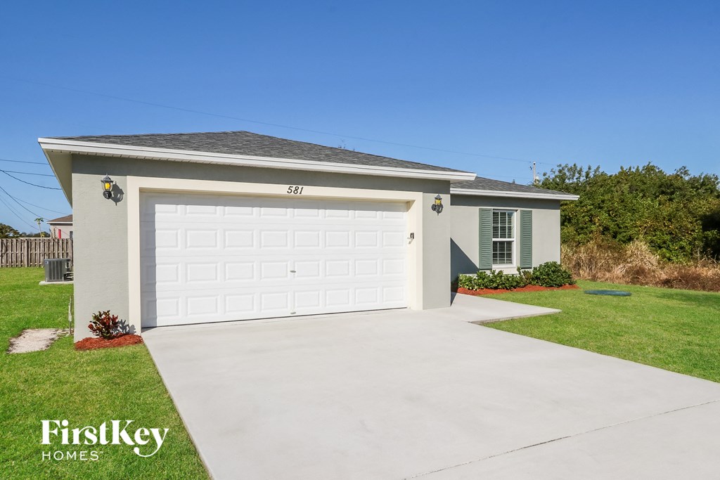 a white house with a white garage door