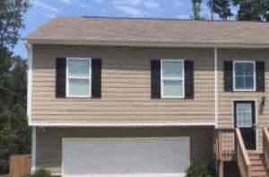 A two-story house with a garage and a front porch.