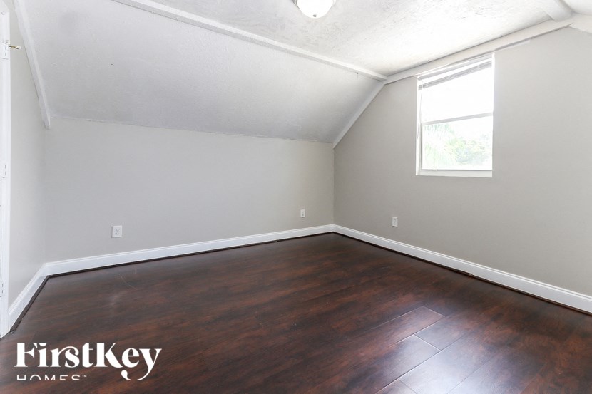 A room with wooden flooring and a window.
