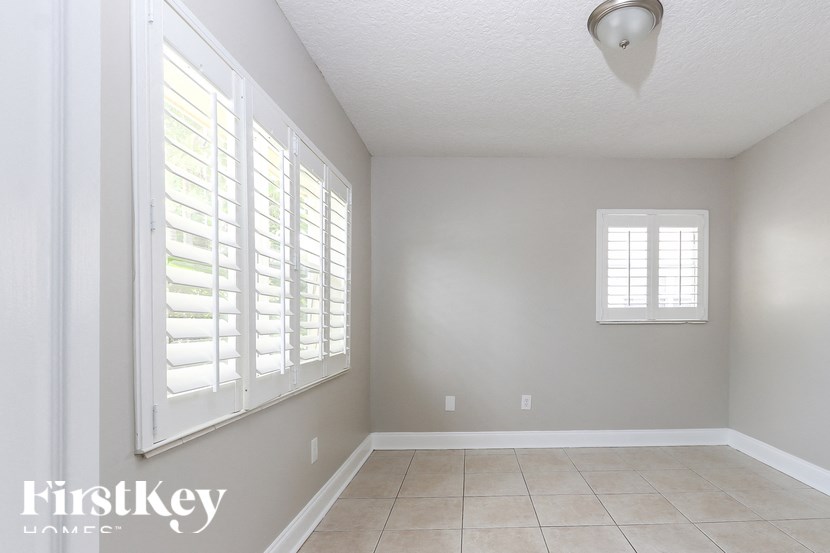 A room with a window and a tiled floor.